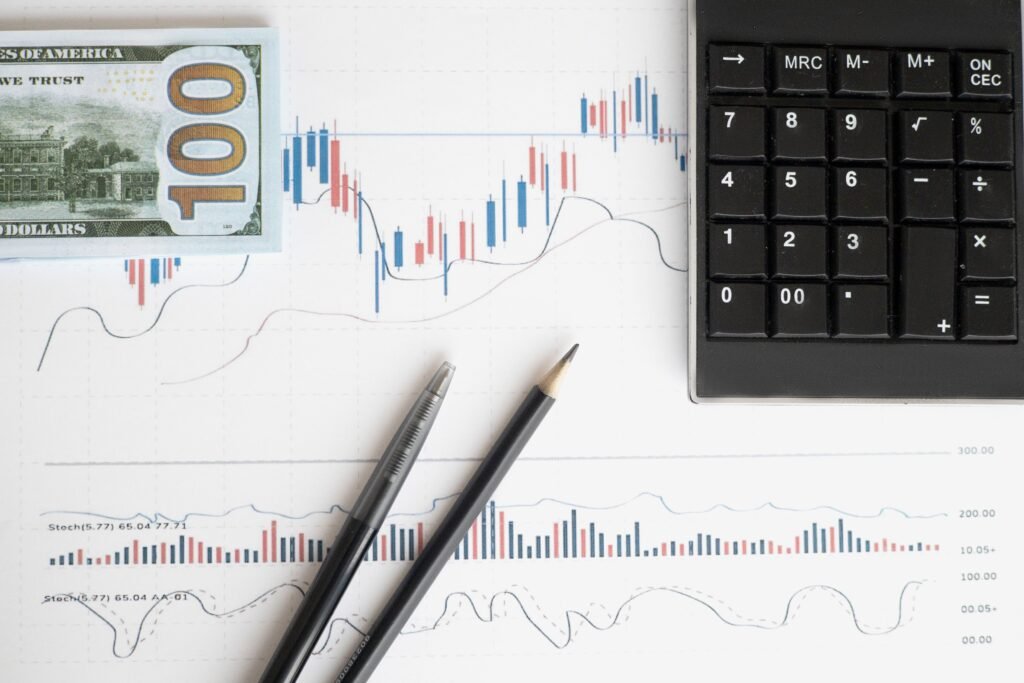 Financial charts, calculator and pen for business analysis — Business Valuation in Guildford & Surrey