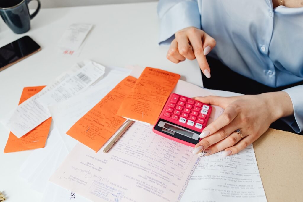 Receipts, calculator and paperwork organised on a desk — VAT accountants in Guildford & Surrey