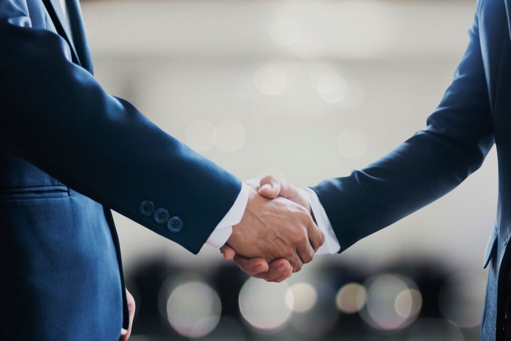Professionals shaking hands on a business valuation agreement