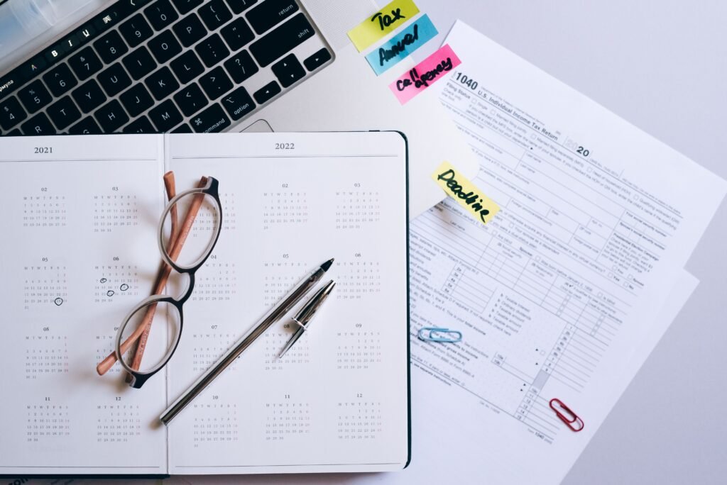 Payslip, calculator and notebook on a desk — Payroll services in Guildford & Surrey