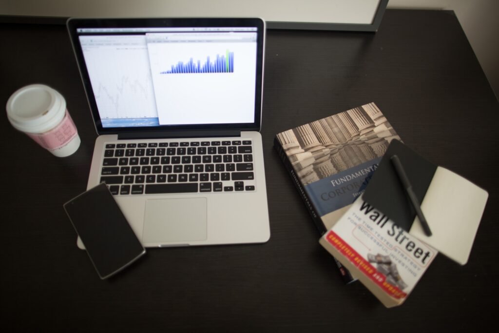 Financial statements and laptop charts on a tidy desk — Accountants in Guildford & Surrey