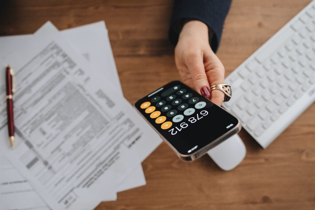 Calculator and tax documents on a desk — Corporation Tax accountants in Guildford & Surrey