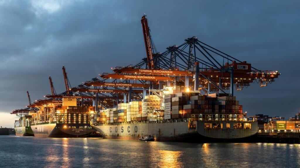 Container terminal at dusk — customs duty, import VAT and international trade accounting, Guildford & UK