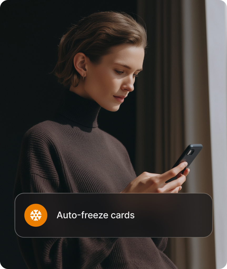 Business owner using the Revolut Business app on a phone, with the auto-freeze cards control shown