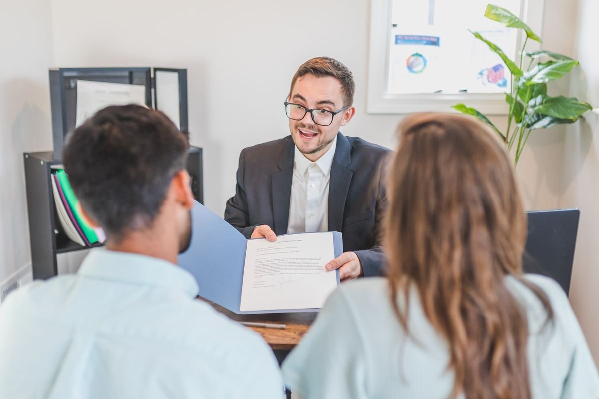 Accountant presenting a set of accounts to two clients in a meeting — accountants in Surrey, TaxDigit