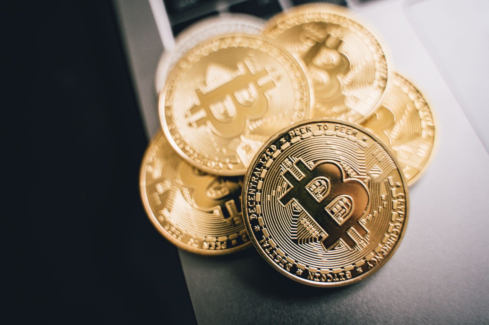 A stack of gold Bitcoin coins, representing a section 104 pool of cryptoassets