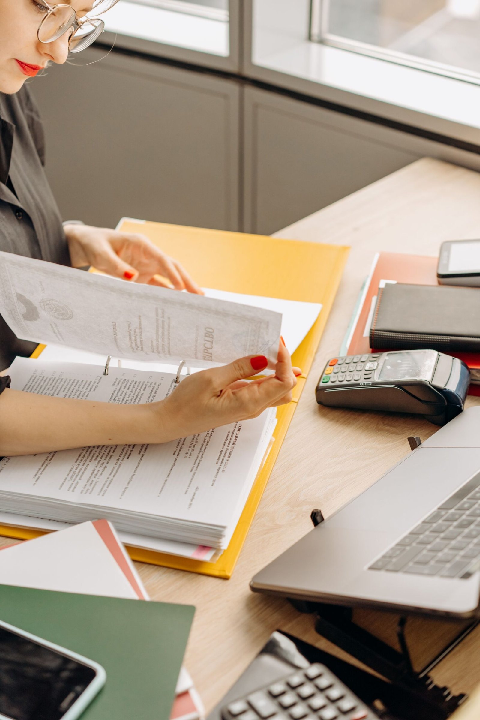Reviewing financial paperwork at a desk, representing Self Assessment capital gains reporting