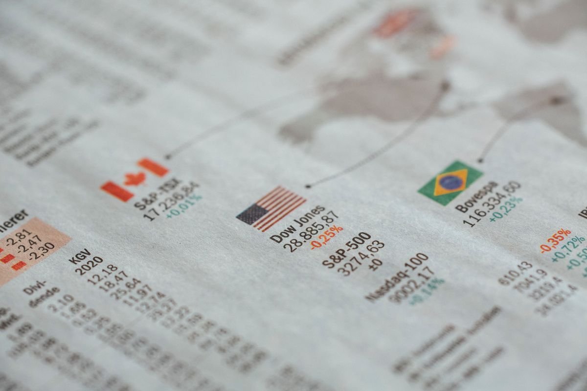 A newspaper page of global financial market statistics by country, representing cross-border crypto tax reporting