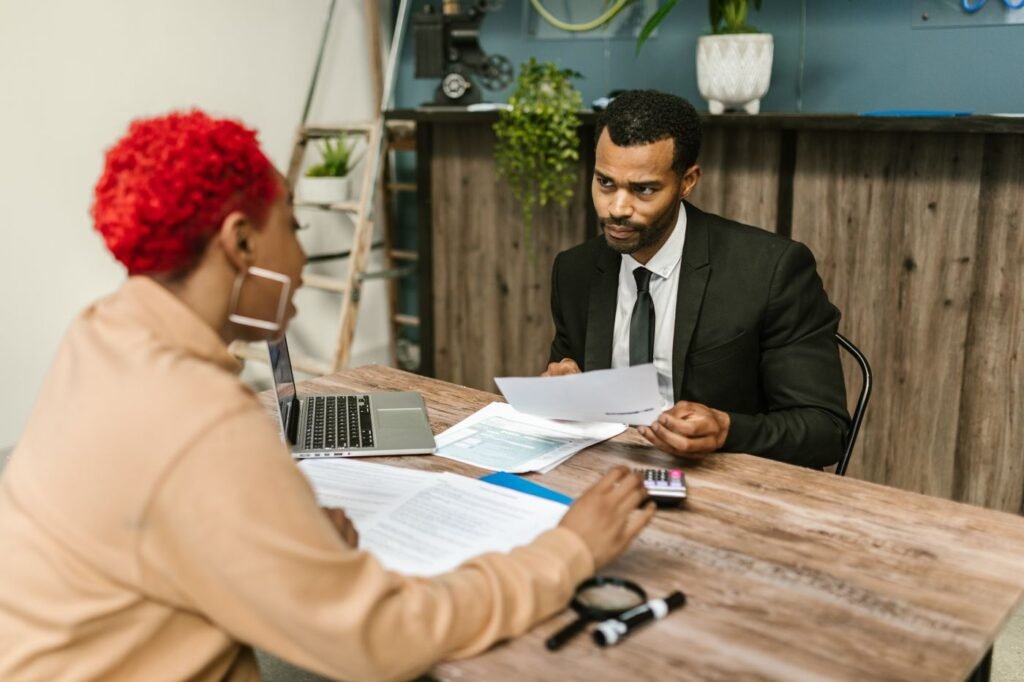Two professionals reviewing financial documents together in an office