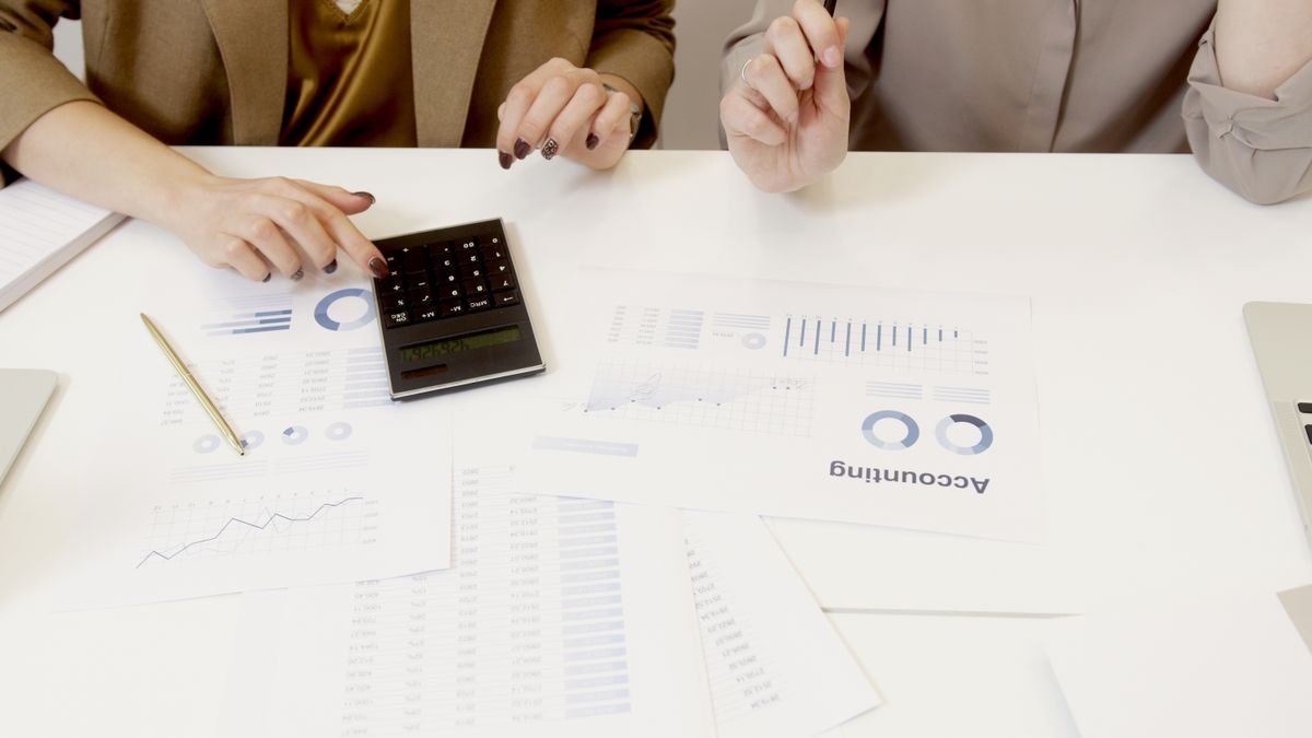 Two professionals reviewing financial documents together, representing an HMRC crypto enquiry settlement negotiation