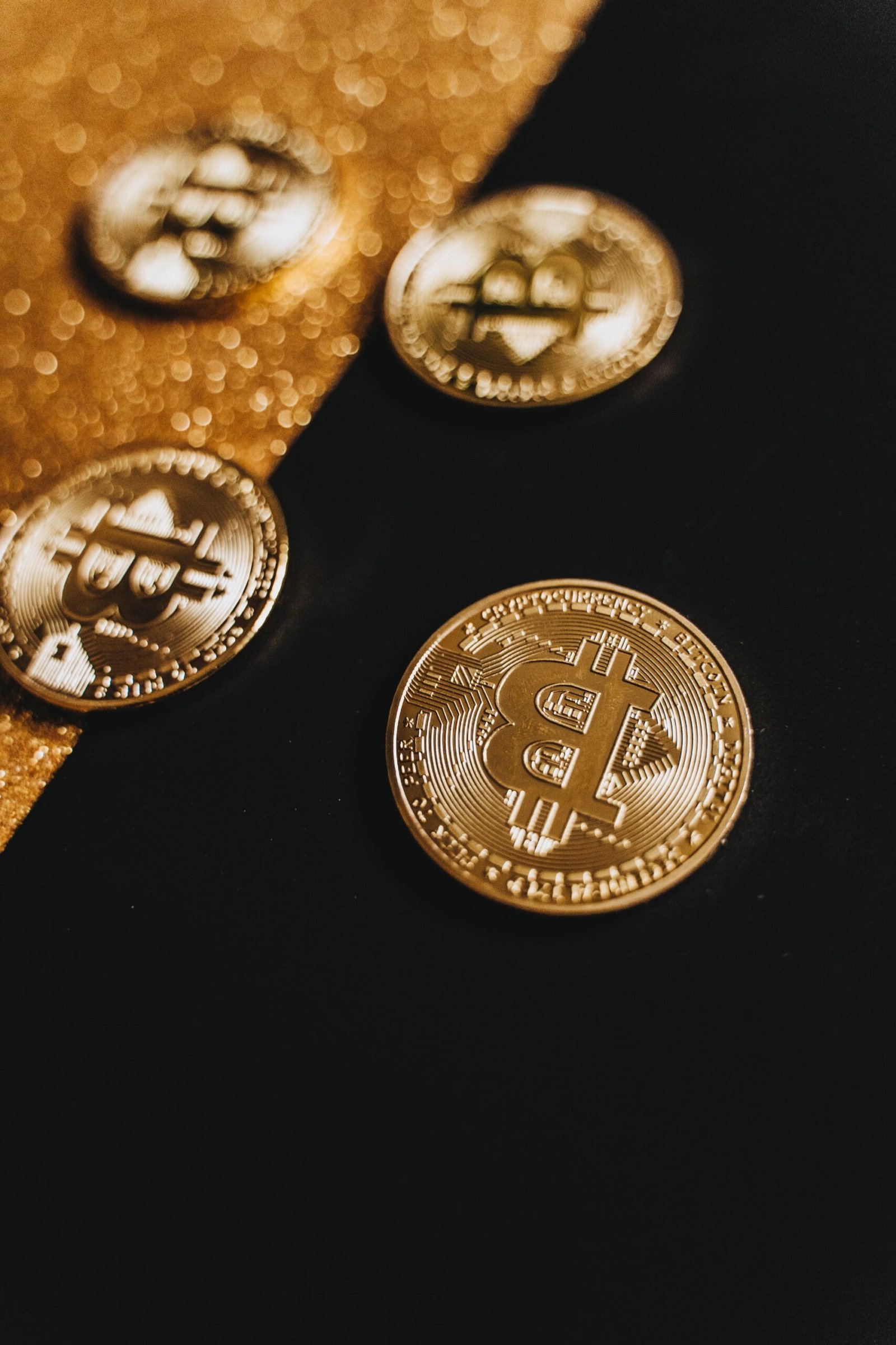 Gold Bitcoin coins on a black and gold background