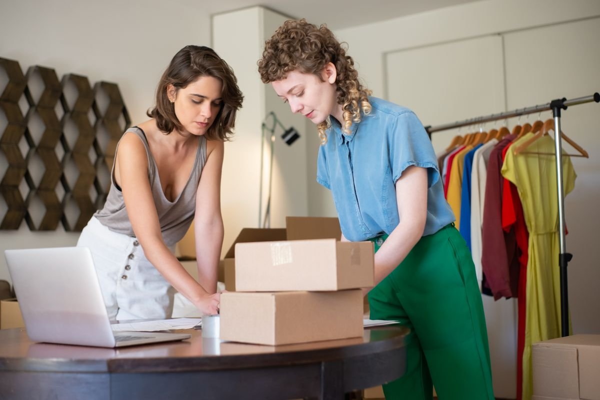 Small business owners boxing up stock for online orders — Amazon and Shopify seller accounting, TaxDigit