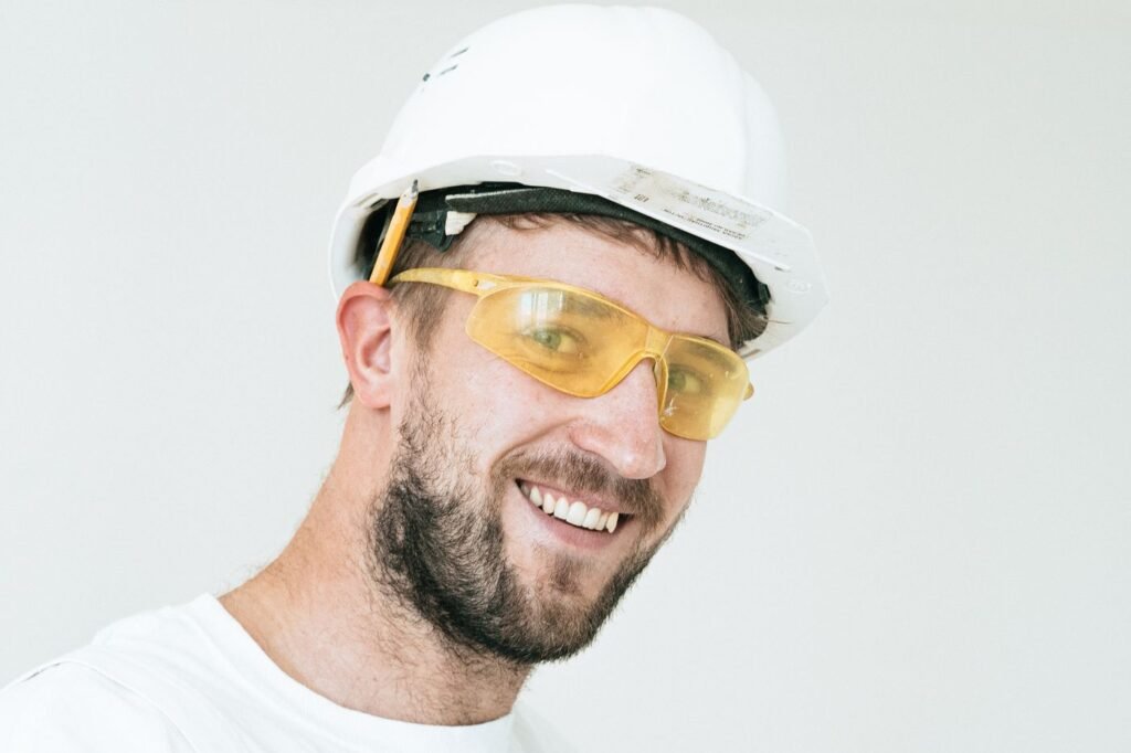 Construction worker in hard hat and safety goggles, representing CIS subcontractors