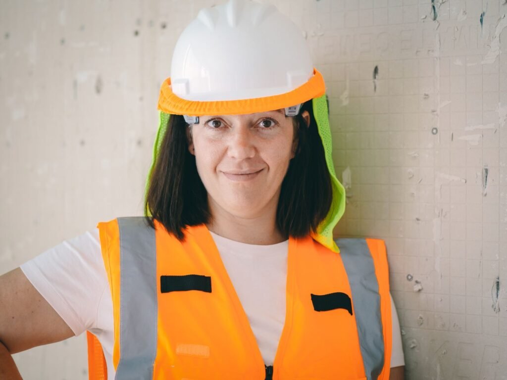 Construction worker in high-visibility vest and hard hat on a UK building project