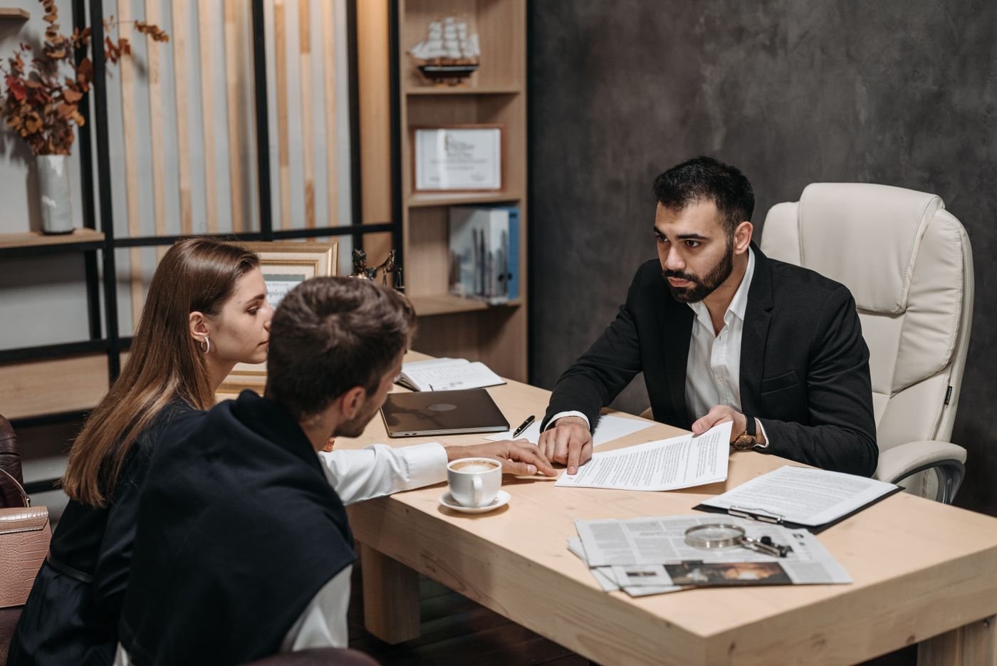 Adviser reviewing documents with clients at an office desk