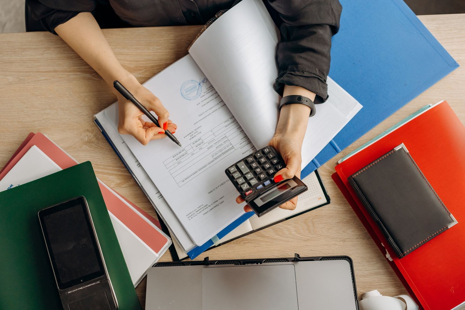 Accountant reviewing financial documents with a calculator to quantify a crypto loss