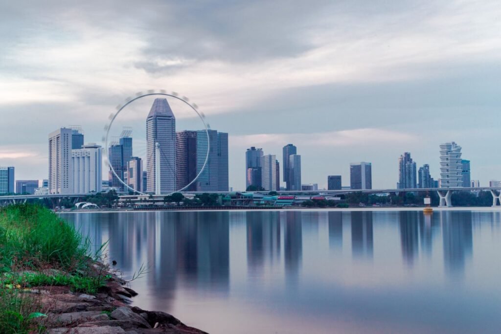 Singapore Flyer and skyline over calm water