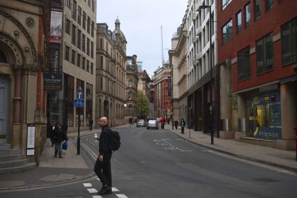 Manchester city centre street with historic architecture, where TaxDigit serves Spanish-speaking business owners
