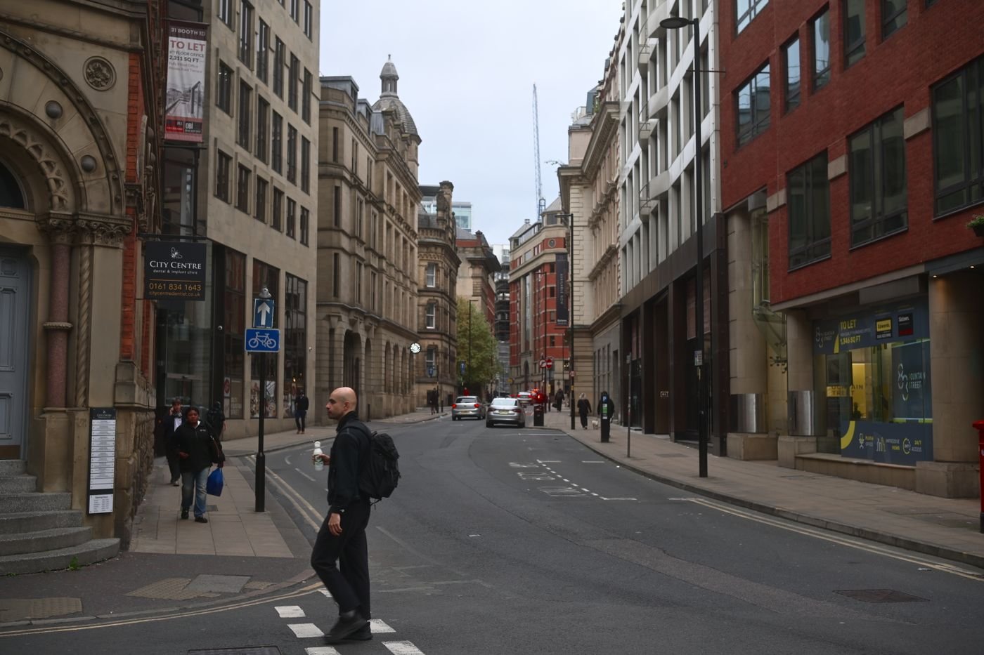 Manchester city centre street with historic architecture, where TaxDigit serves Spanish-speaking business owners