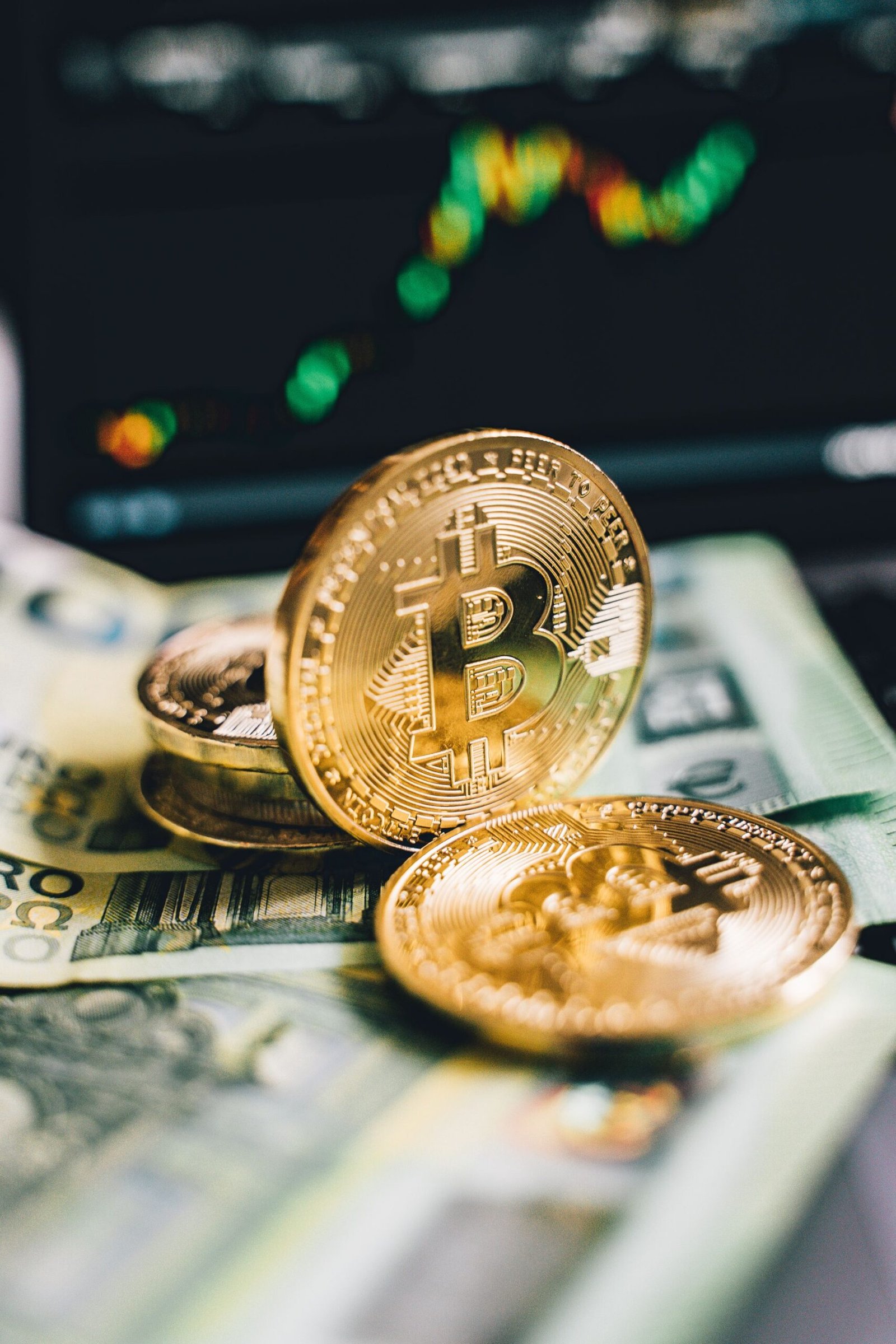 Gold Bitcoin coins resting on banknotes beside a price chart, representing staking rewards