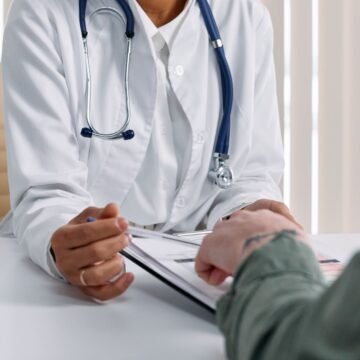 Doctor reviewing financial paperwork with a client