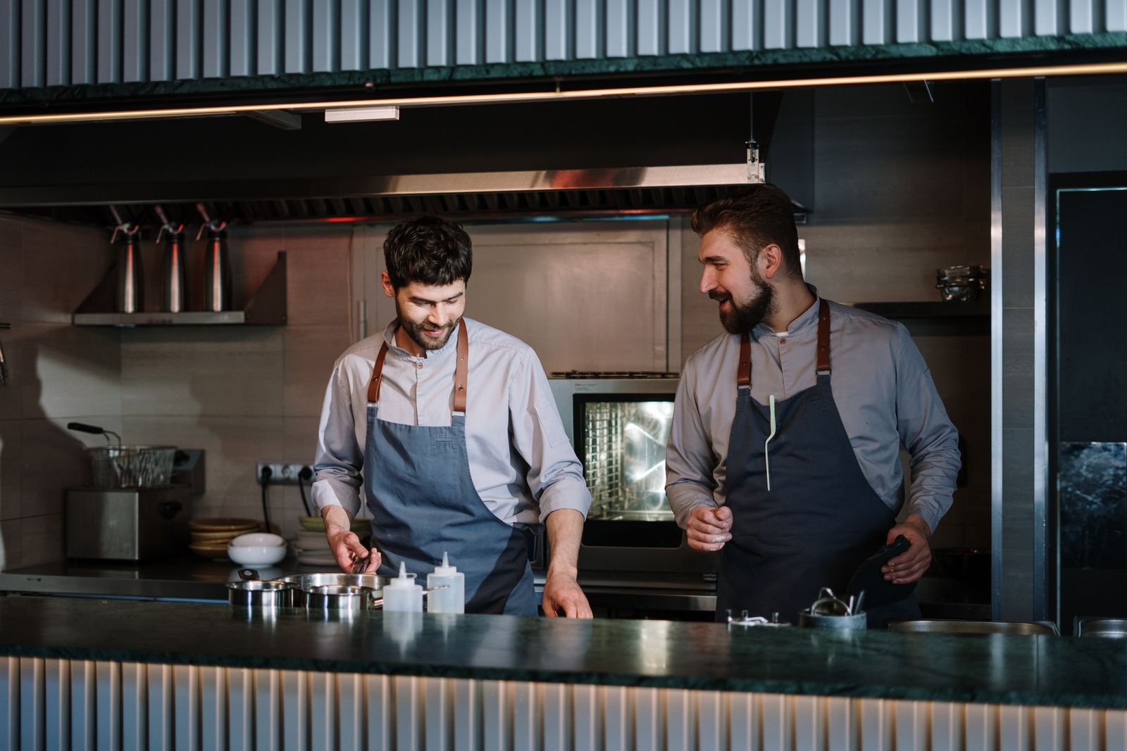 Chefs preparing food in a professional restaurant kitchen — TaxDigit, best Bengali accountant in the UK
