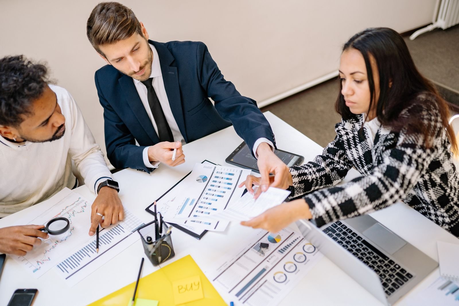Business advisers reviewing accounts and charts with a client — TaxDigit Chinese accountancy services