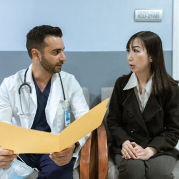 Hospital consultant discussing notes with a patient