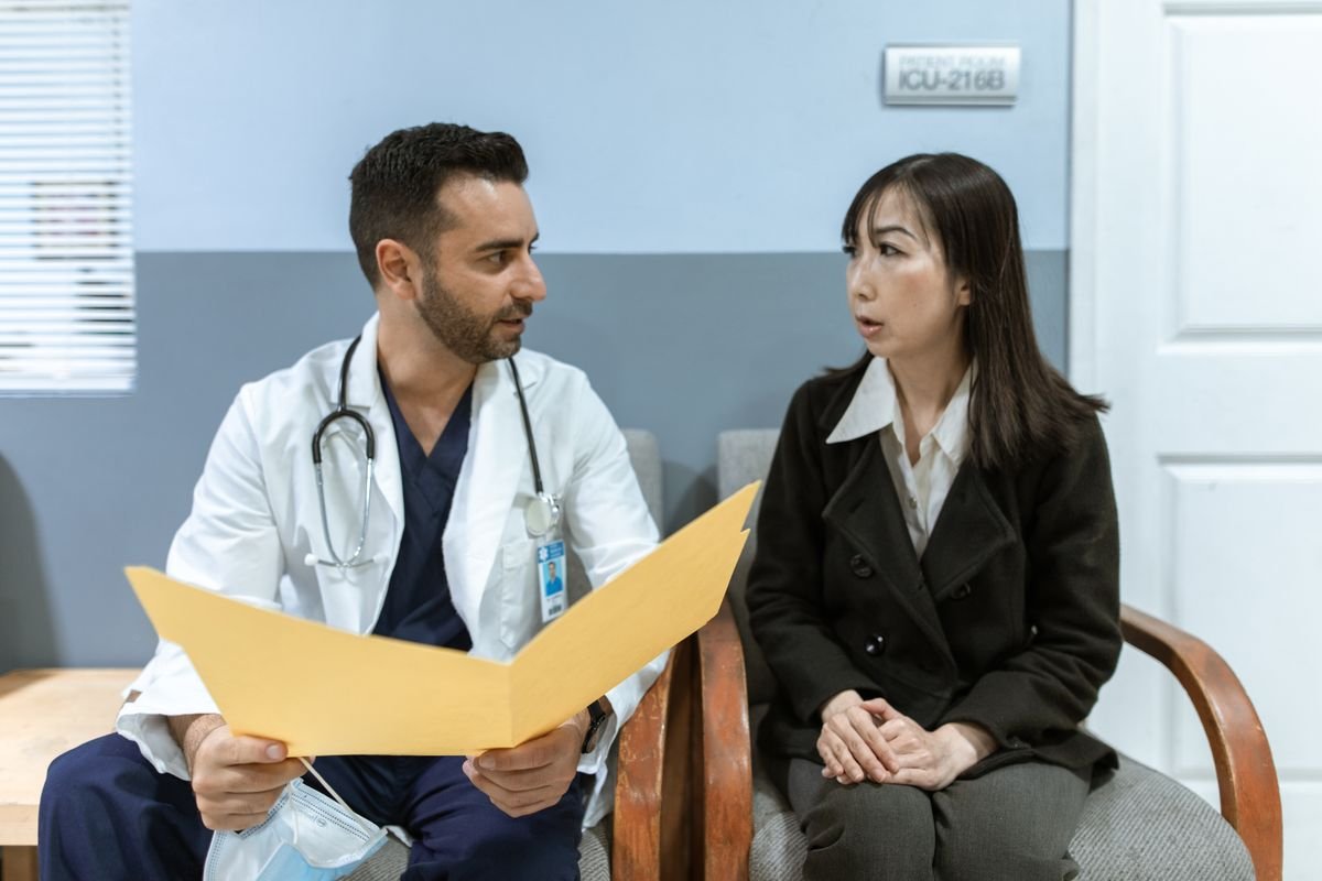 Hospital consultant discussing notes with a private patient — accountants for consultants in private practice