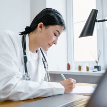 Doctor completing paperwork at a desk