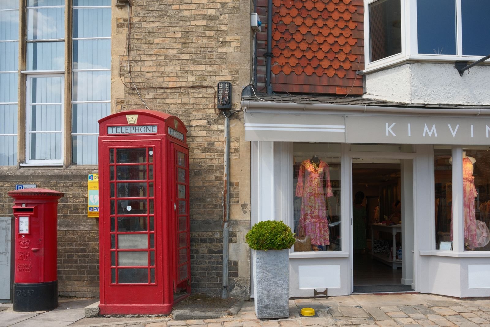 Red telephone box beside a British boutique shopfront — TaxDigit chartered certified accountants for UK small businesses