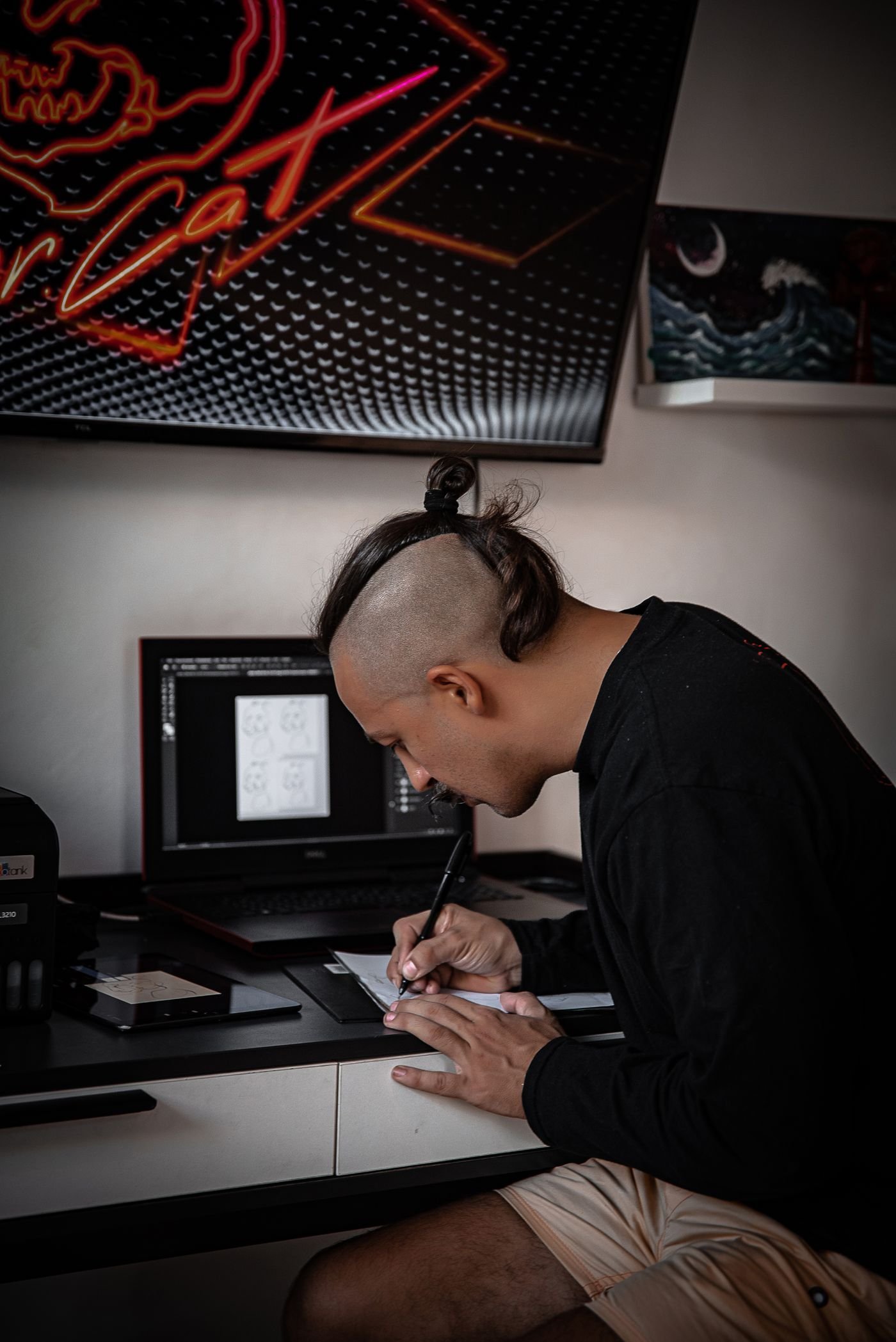 Digital designer working on artwork at a large screen in a creative studio