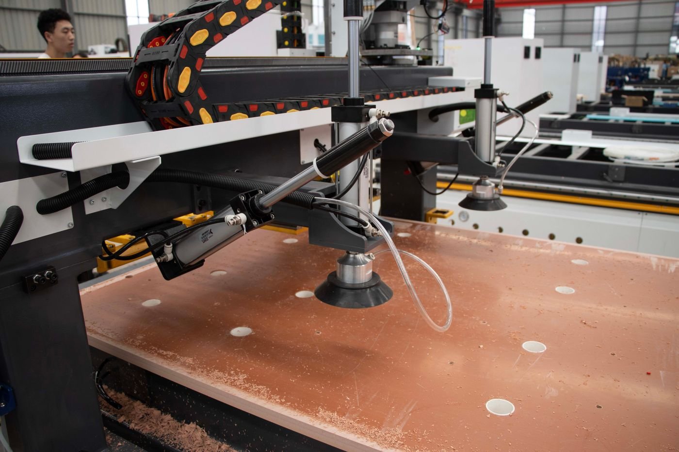 Industrial CNC machining centre cutting a metal component on a factory floor