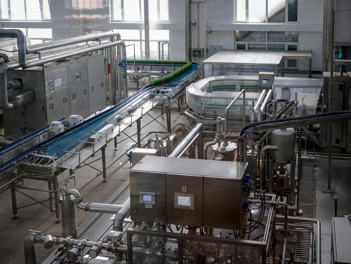 Bottling line running inside a modern food and drink manufacturing facility