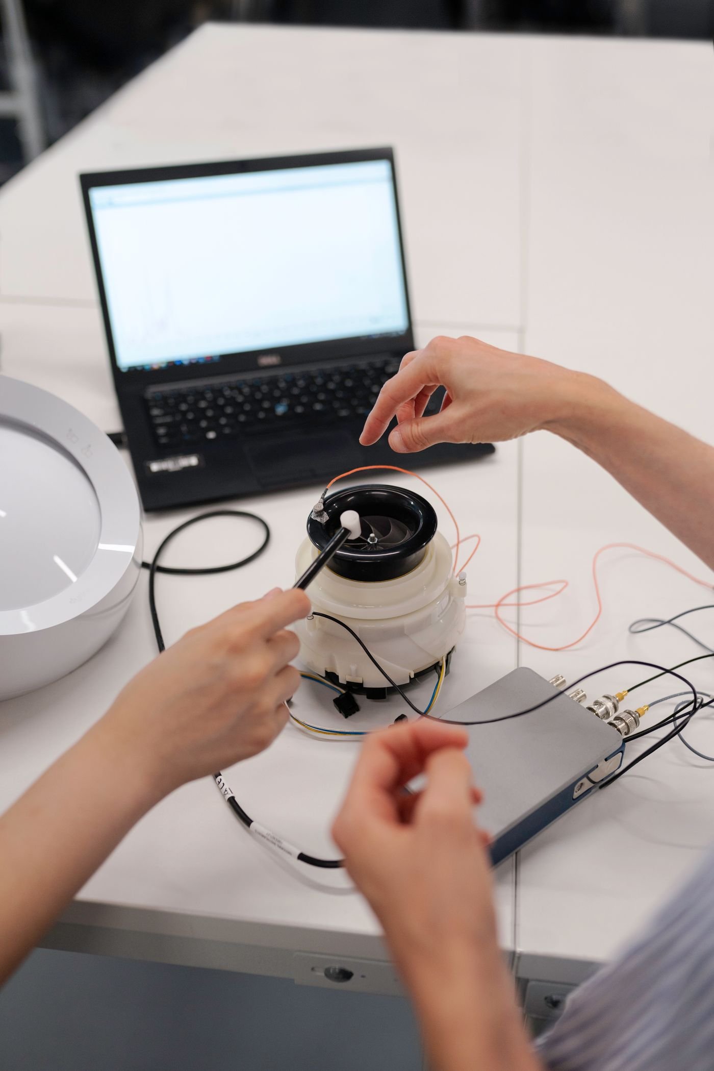 Engineers testing a prototype product on a workbench in a development workshop