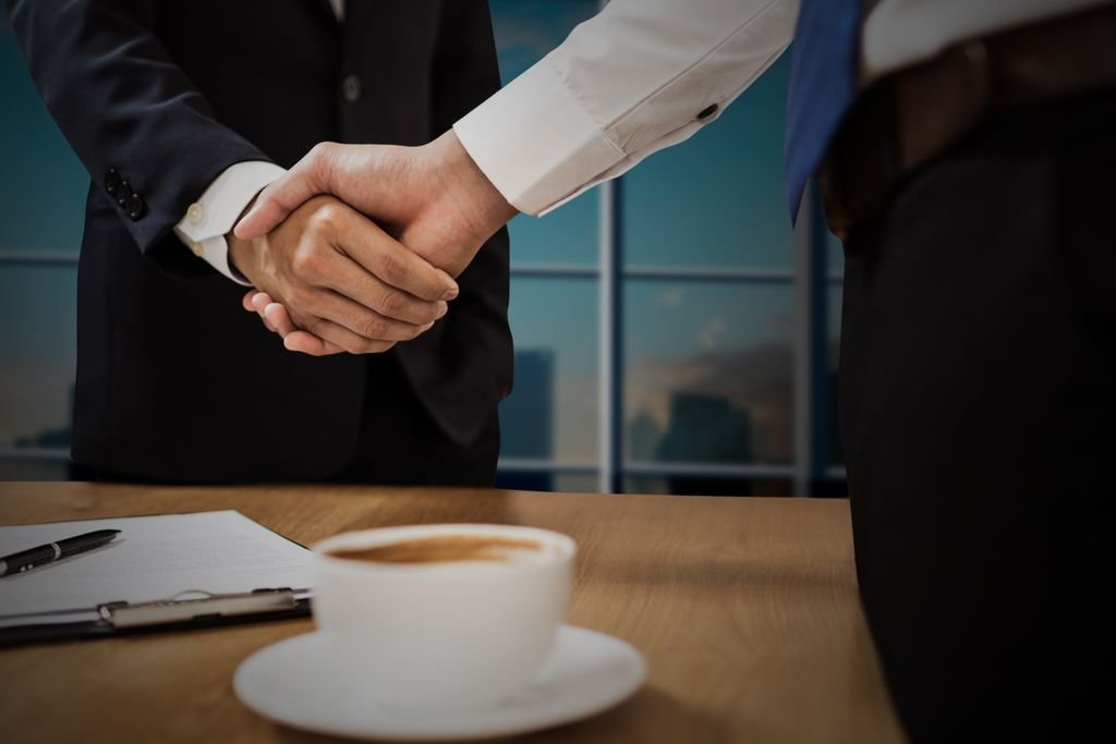 Handshake in a UK office after agreeing a UK market entry plan