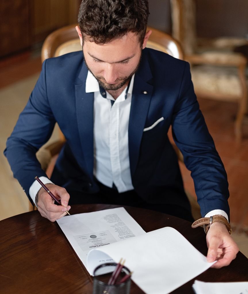 Company director signing UK business bank account documents prepared and certified by TaxDigit